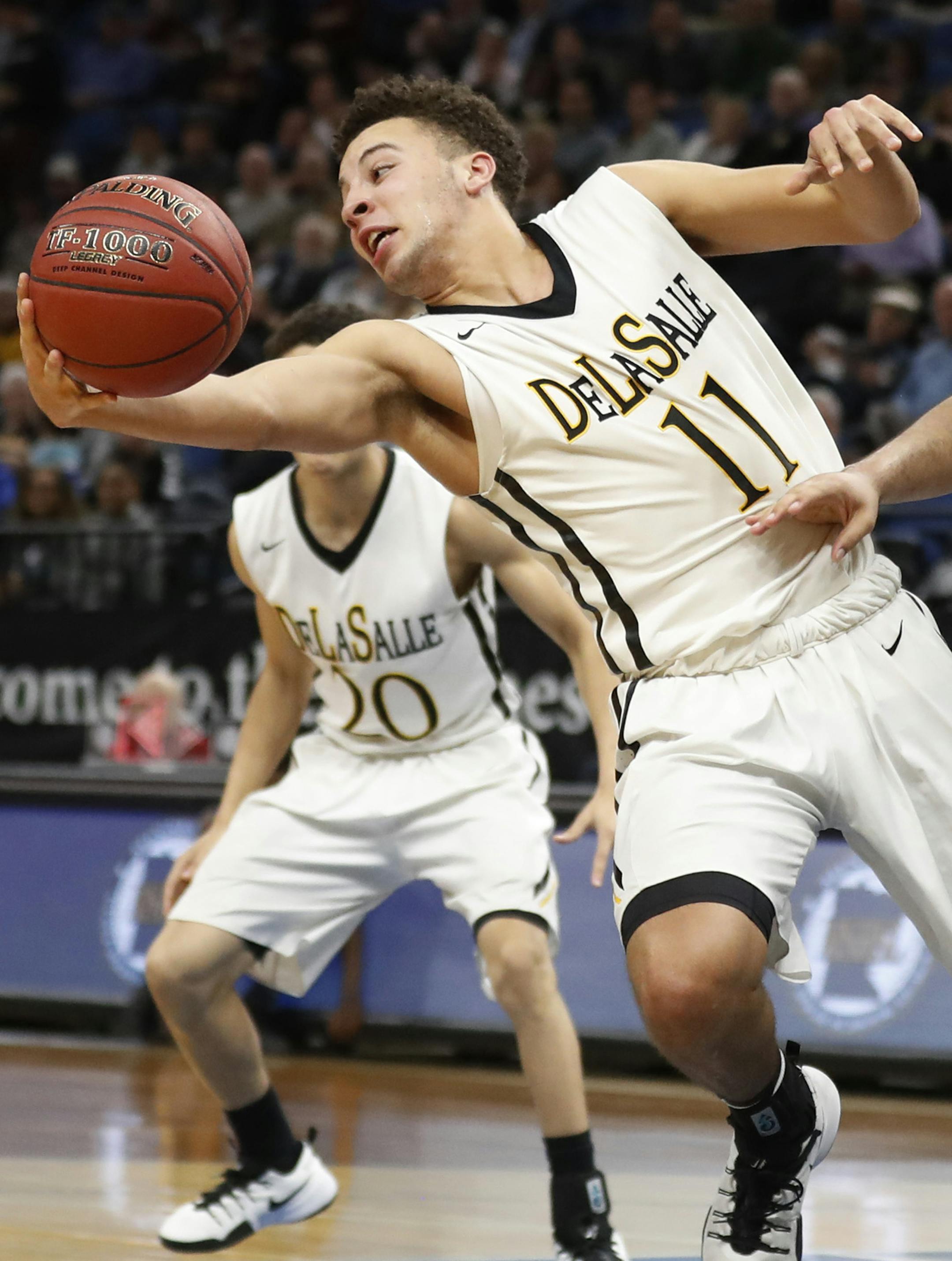 Gabe Kalscheur of DeLaSalle rebounds over Jarvis Wright of Columbia Heights during semifinal class 3A basketball action at Target Center Thursday March 23, 2017 in Minneapolis, MN.] DeLaSalle Islanders beat Columbia Heights Hylanders 86-60. JERRY HOLT ï jerry.holt@startribune.