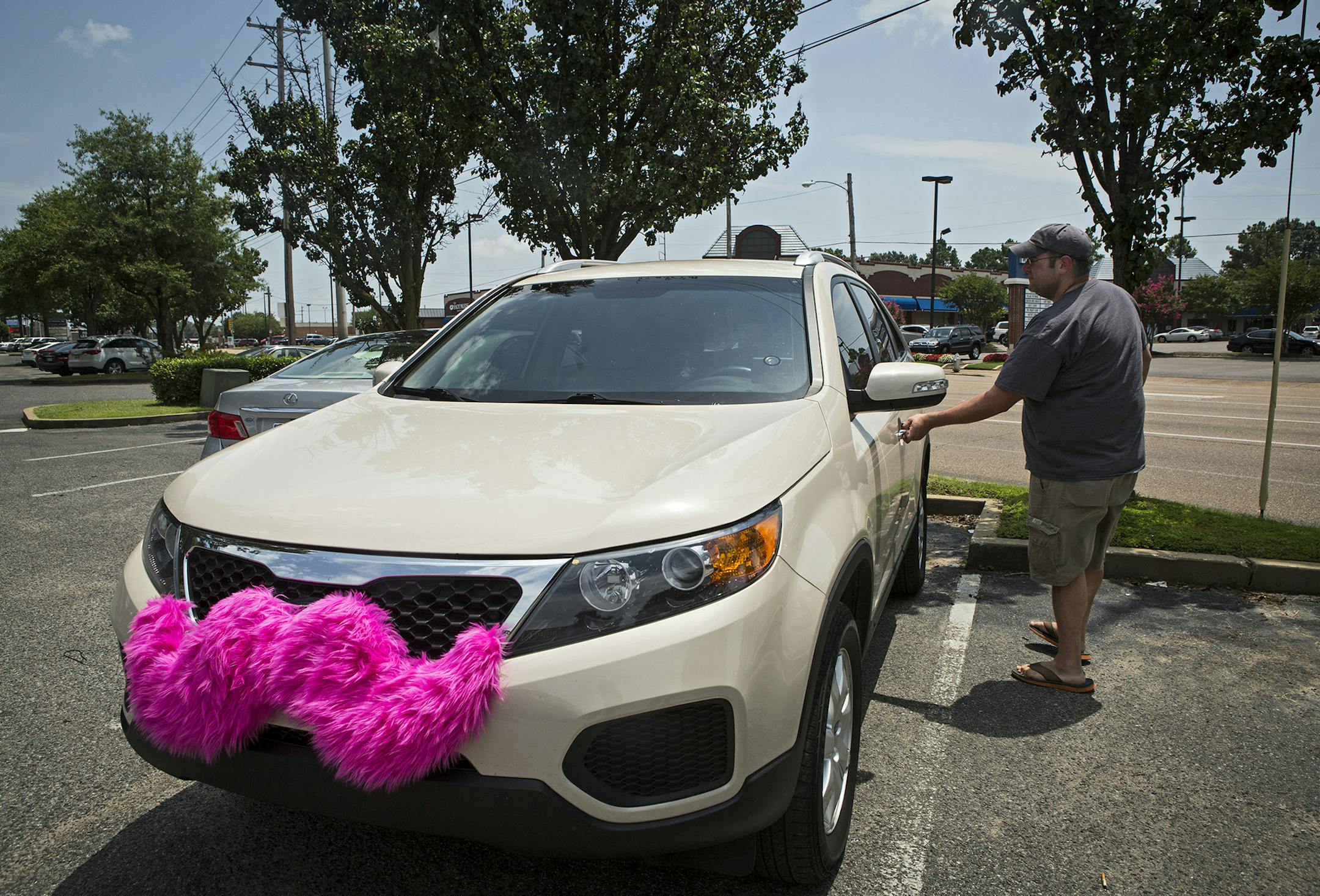July 14, 2014 - Lyft driver Geoffrey Frisch, 36, enters his vehicle before heading to the Memphis International Airport Monday afternoon, July 14, 2014. Memphis has issued a cease-and-desist order against the ride-share service, which has been in service in the city since April, until they meet the same regulatory requirements as taxis and other vehicles for hire. (AP Photo/The Commercial Appeal, Yolanda M. James) ORG XMIT: MIN2014071714545556