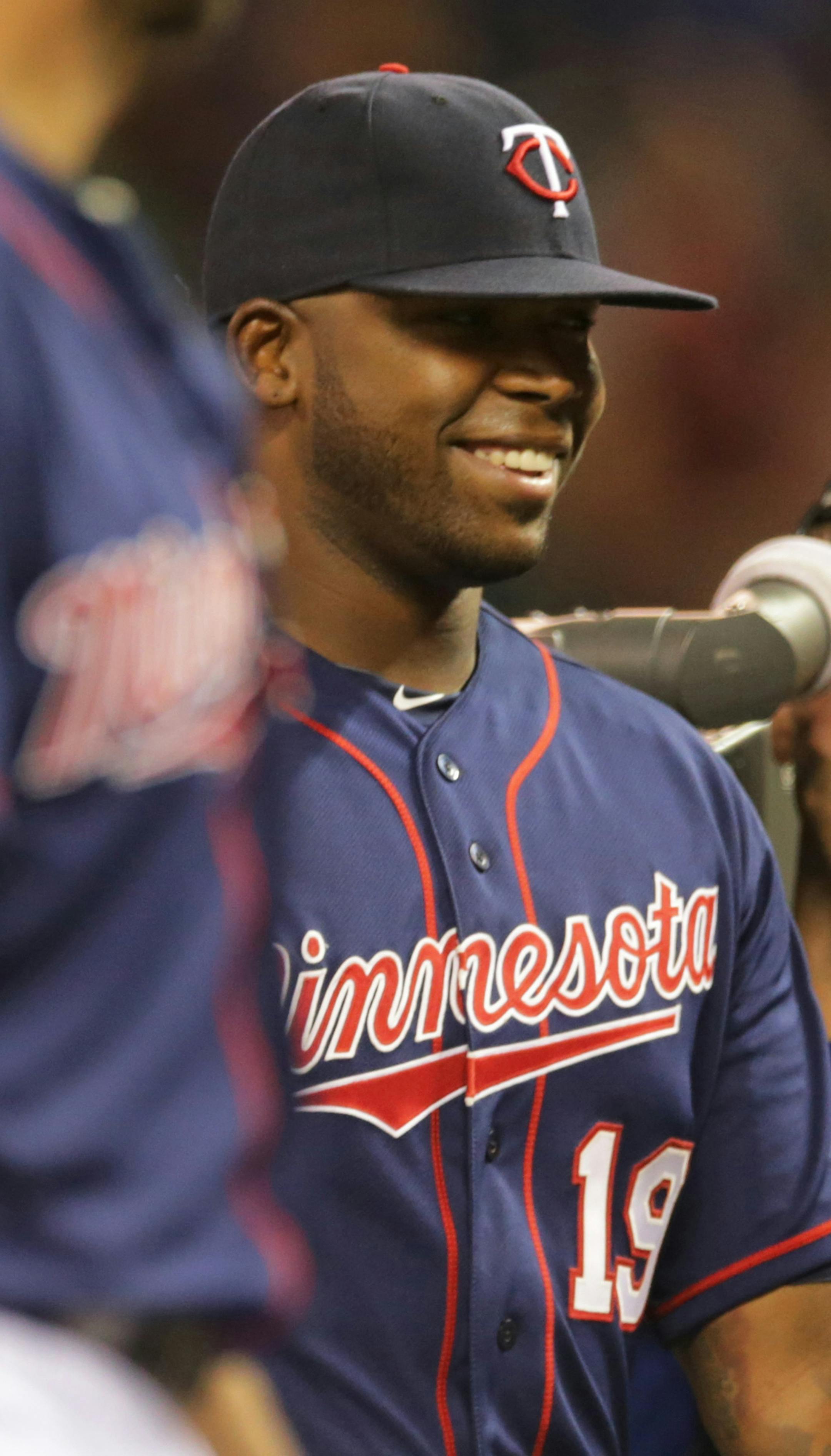 Minnesota Twins' Kennys Vargas smiles as he the team celebrates a 3-1 win over the San Diego Padres in a baseball game, Tuesday, Aug. 5, 2014, in Minneapolis. Vargas hit a three-run home run in the sixth inning. (AP Photo/Jim Mone)