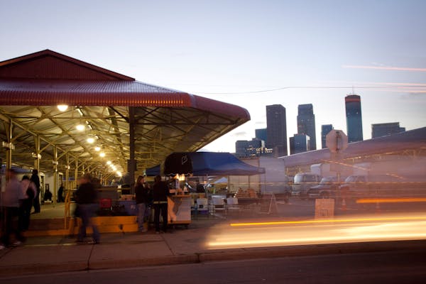 The Minneapolis Farmers Market stands in front of the city skyline of Minneapolis, Minnesota, U.S., on Saturday, Sept. 21, 2013. The House passed a me