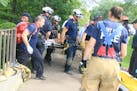 St. Paul Fire Department personnel hoisted the hiker up in a basket to the top of the bluff near Mississippi River Boulevard and Summit Avenue about 1