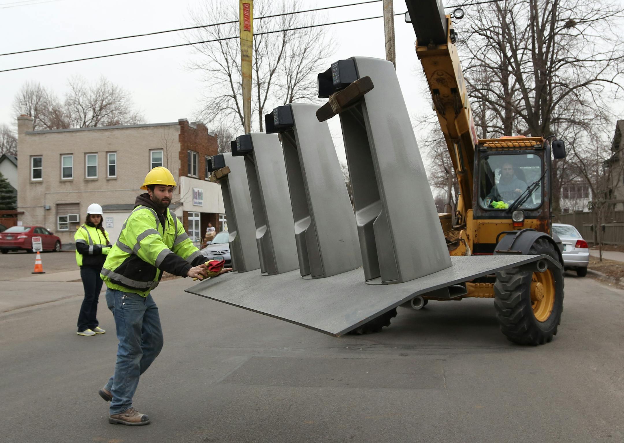 Tucker Libby, of Nice Ride, guided part of the bike rack in place. ] (KYNDELL HARKNESS/STAR TRIBUNE) kyndell.harkness@startribune.com Infant of the Birchwood Cafe in Minneapolis Min., Wednesday, March 18, 2015.