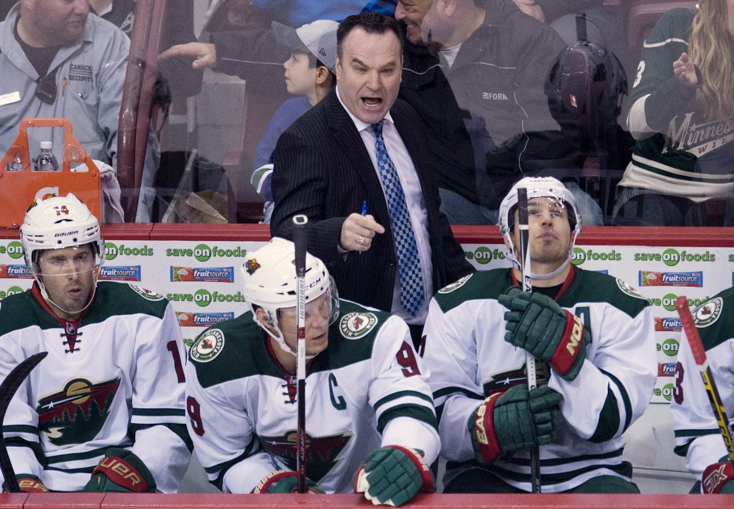 Wild interim coach John Torchetti gave instructions on the bench during his debut Monday night at Vancouver.