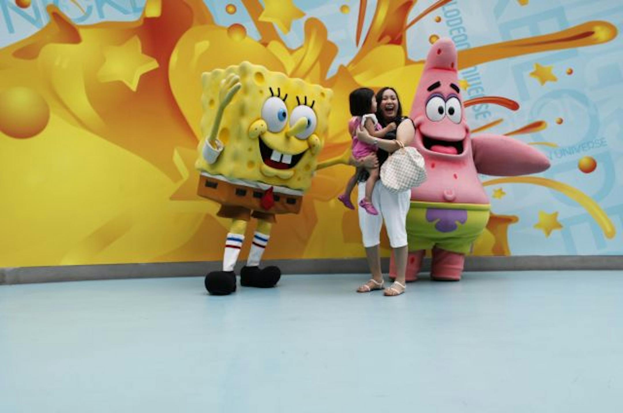 Lisa Dalman of Chicago tries to comfort her daughter Samantha, 2, while posing for a picture with the characters of Sponge Bob Square Pants Saturday afternoon at Nickelodeon Universe in the Mall of America.