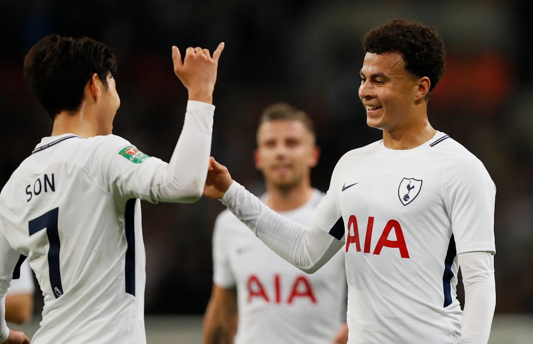 Tottenham's Dele Alli, right, celebrates with teammate Son Heung-min