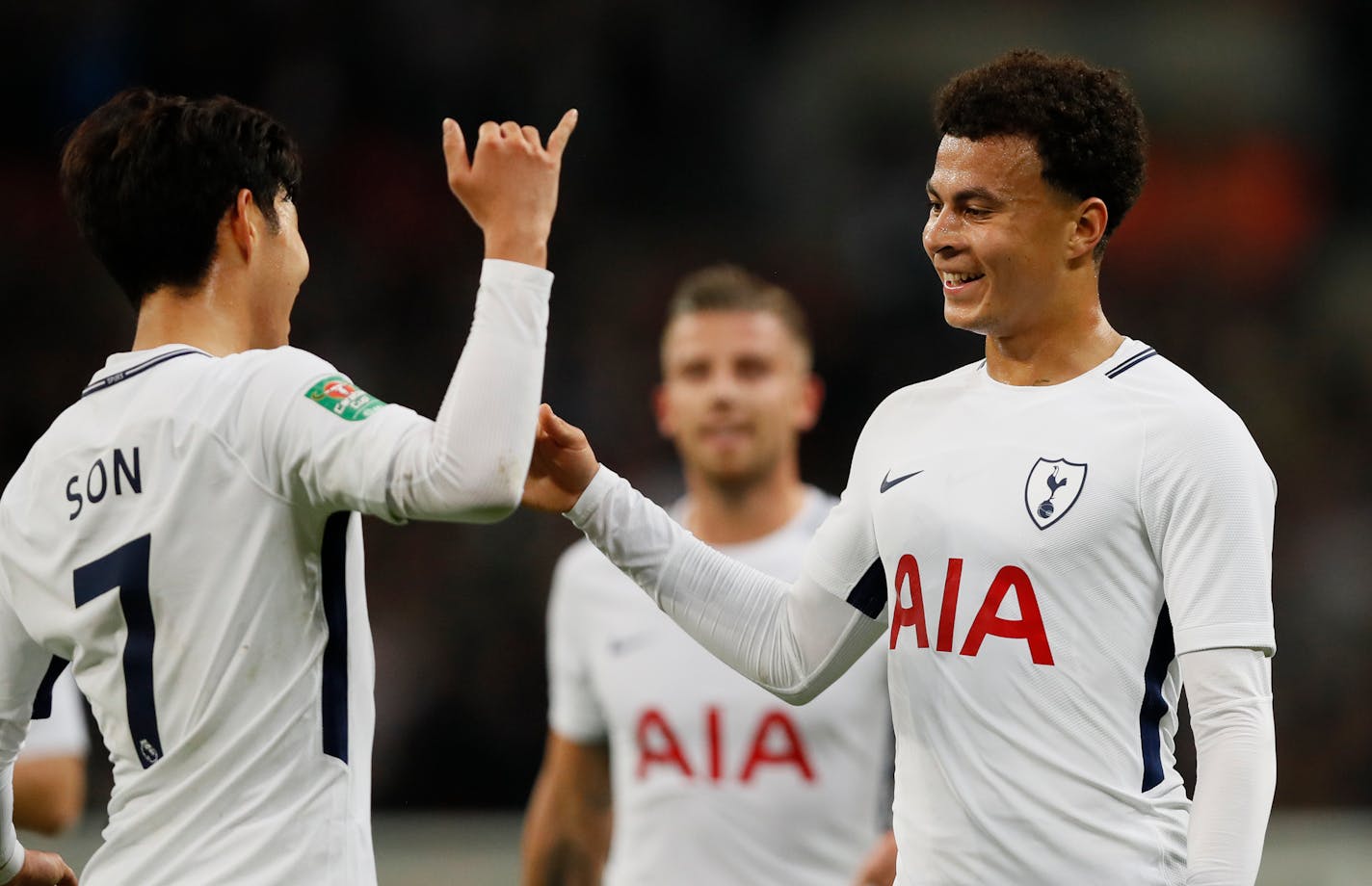 Tottenham's Dele Alli, right, celebrates with teammate Son Heung-min