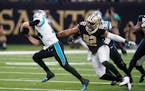 New Orleans Saints defensive end Marcus Davenport (92) pursues Carolina Panthers quarterback Sam Darnold in the first half of an NFL football game in 