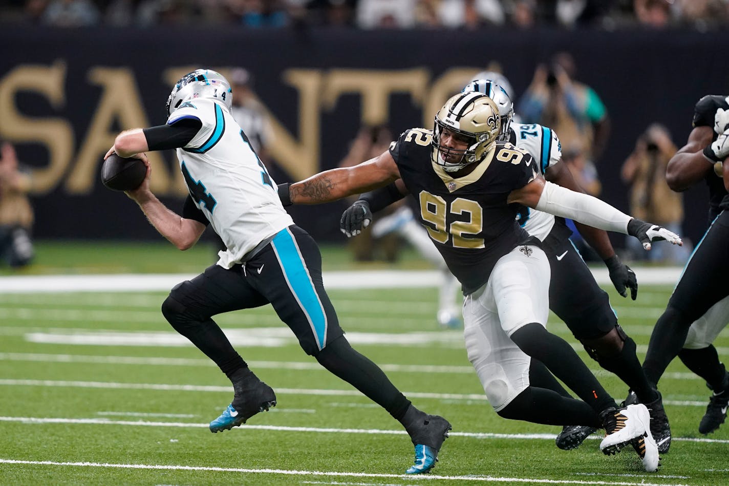 New Orleans Saints defensive end Marcus Davenport (92) pursues Carolina Panthers quarterback Sam Darnold in the first half of an NFL football game in New Orleans, Sunday, Jan. 8, 2023. (AP Photo/Gerald Herbert)