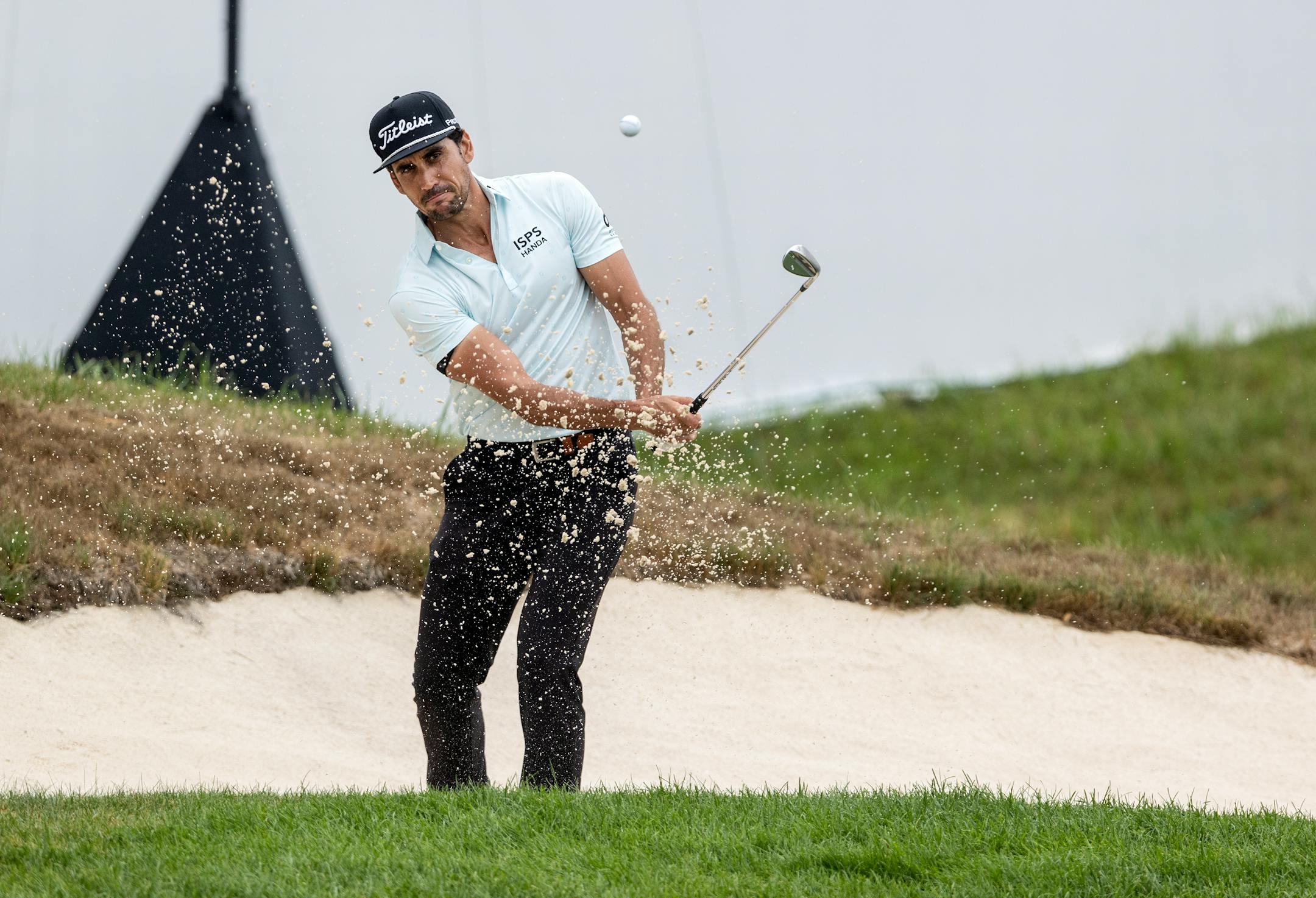 Rafa Cabrera-Bello hit out of a sand trap on the 18th hole during the first round of the 3M Open in Blaine.