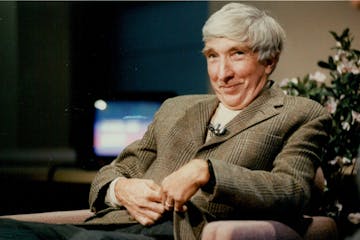 October 10, 1989 John Updike on the set of KTHI-11 news in Fargo, where he was guest on the 5 p.m. news show. He's unhooking the microphone he was wea