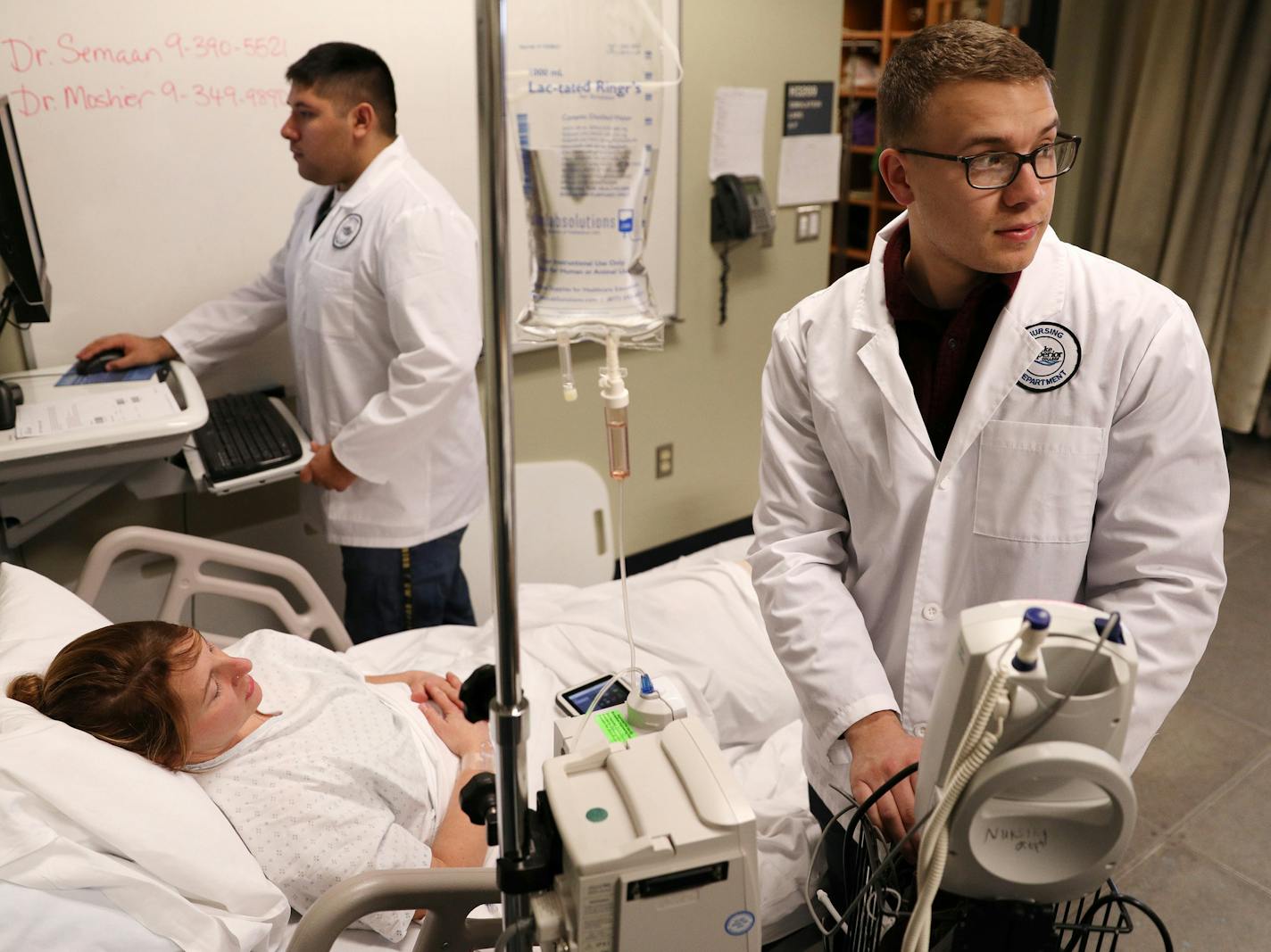 Matthew Girtz, right, and Andrew Hutton worked with instructor Tracy Moshier who was acting as a patient during a simulated situation in the nursing skills lab. ] ANTHONY SOUFFLE &#xef; anthony.souffle@startribune.com Army medics Matthew Girtz and Andrew Hutton who are working to become LPNs as part of a fast-track program to recognize their military skills worked with instructors on a simulated situation in the nursing skills lab at Lake Superior College in Duluth, Minn.