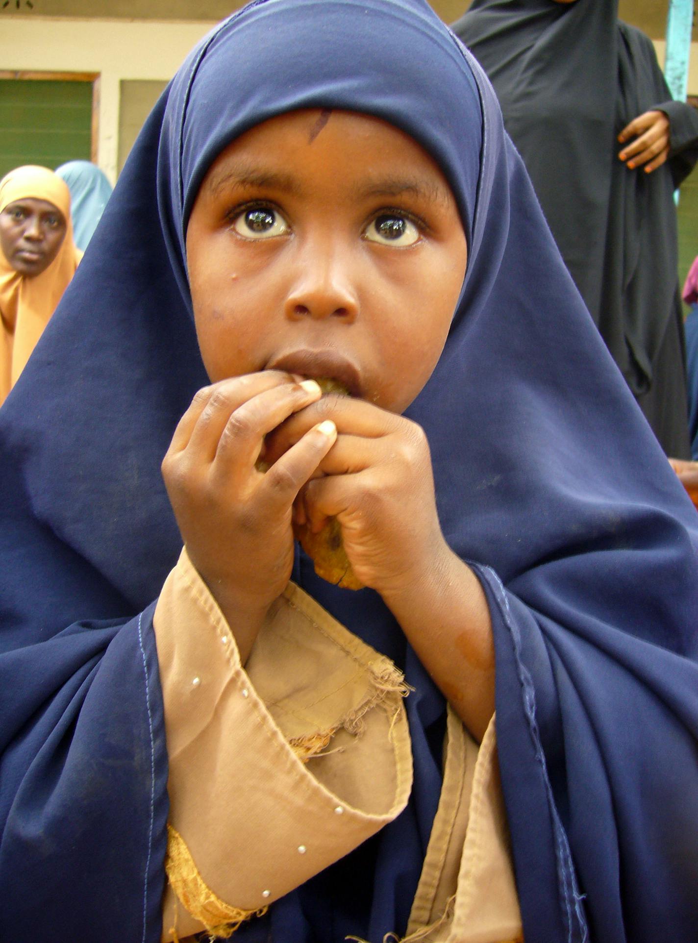 A Somali girl waits to be allowed to enter a U.N. registration center at Dagahaley refugee camp in Daadab, northern Kenya on Thursday June 25, 2009. The bloody conflict in Somalia has created the world's largest refugee camp, with 500 hungry and exhausted refugees pouring into this wind-swept camp in neighboring Kenya every day, according to the U.N. refugee agency. Dadaab, just 50 miles (80 kilometers) from the Somali border, is home to more than 280,000 refugees in an area meant to hold just 9