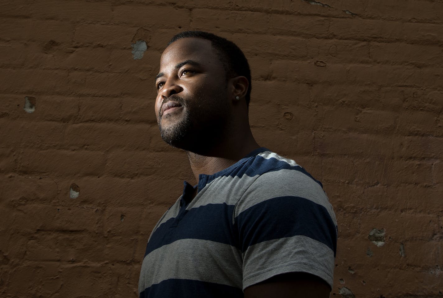 St. Paul native Rashad Turner used to love to go to the State Fair and even worked there as a teenager selling spaghetti. But, now Turner plans to protest this weekend with other Black Lives Matter activists despite the death threats he has received and warnings from the police. ] CARLOS GONZALEZ cgonzalez@startribune.com - August 27, 2015, St. Paul, MN, St. Paul native Rashad Turner used to love to go to the State Fair and even worked there as a teenager selling spaghetti. But, now Turner plans