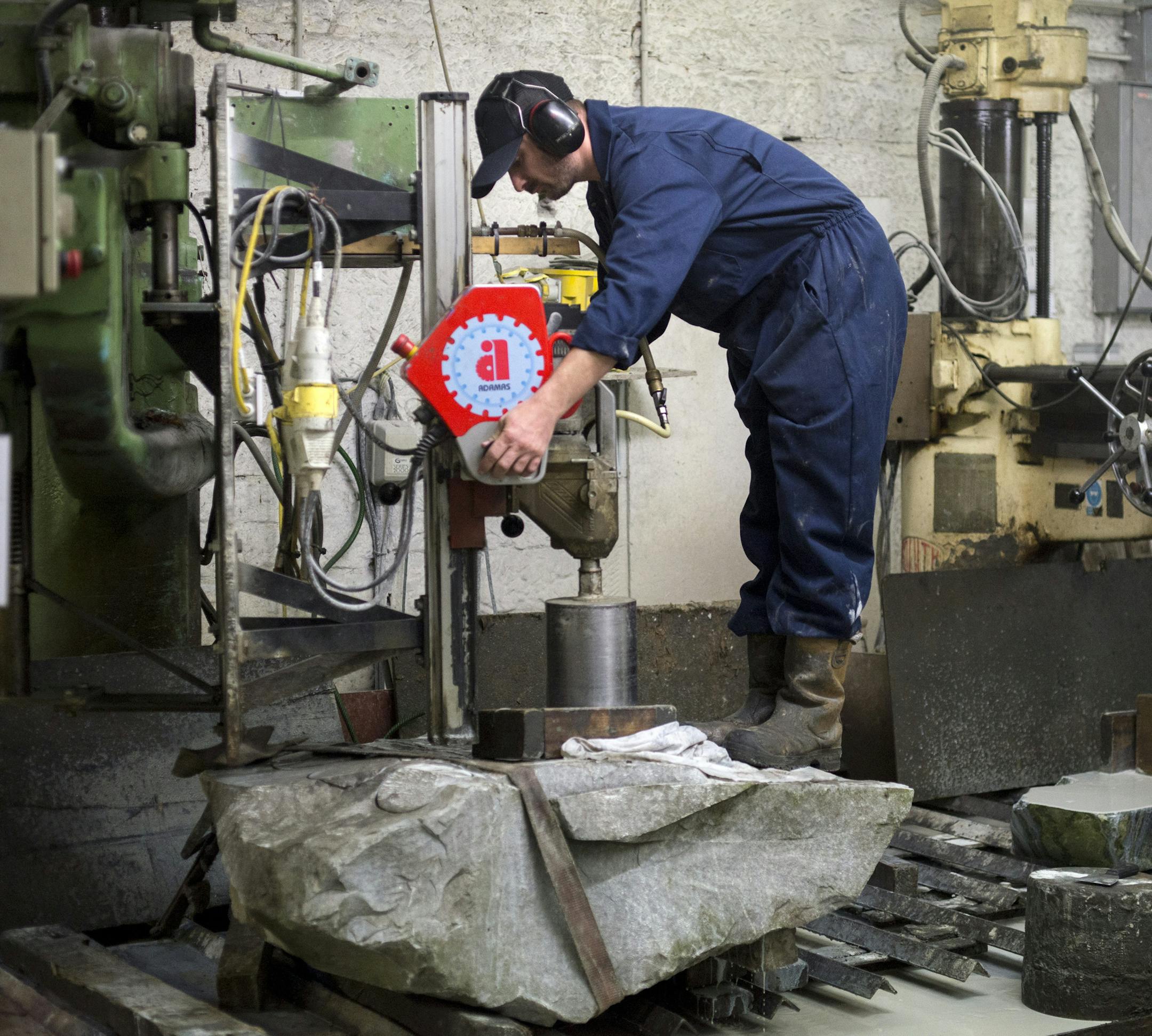 Microgranite quarried on Ailsa Craig is made into Olympic curling stones at Kays of Scotland in Mauchline, Scotland, Oct. 28, 2013. Aisla Craig, an uninhabited 200-acre island off the Scottish coast that has been owned by the same family for 500 years, is the source of a distinctive granite used to make Olympic curling stones, but now the island is for sale at $2.4 million. (Andrew Testa/The New York Times)