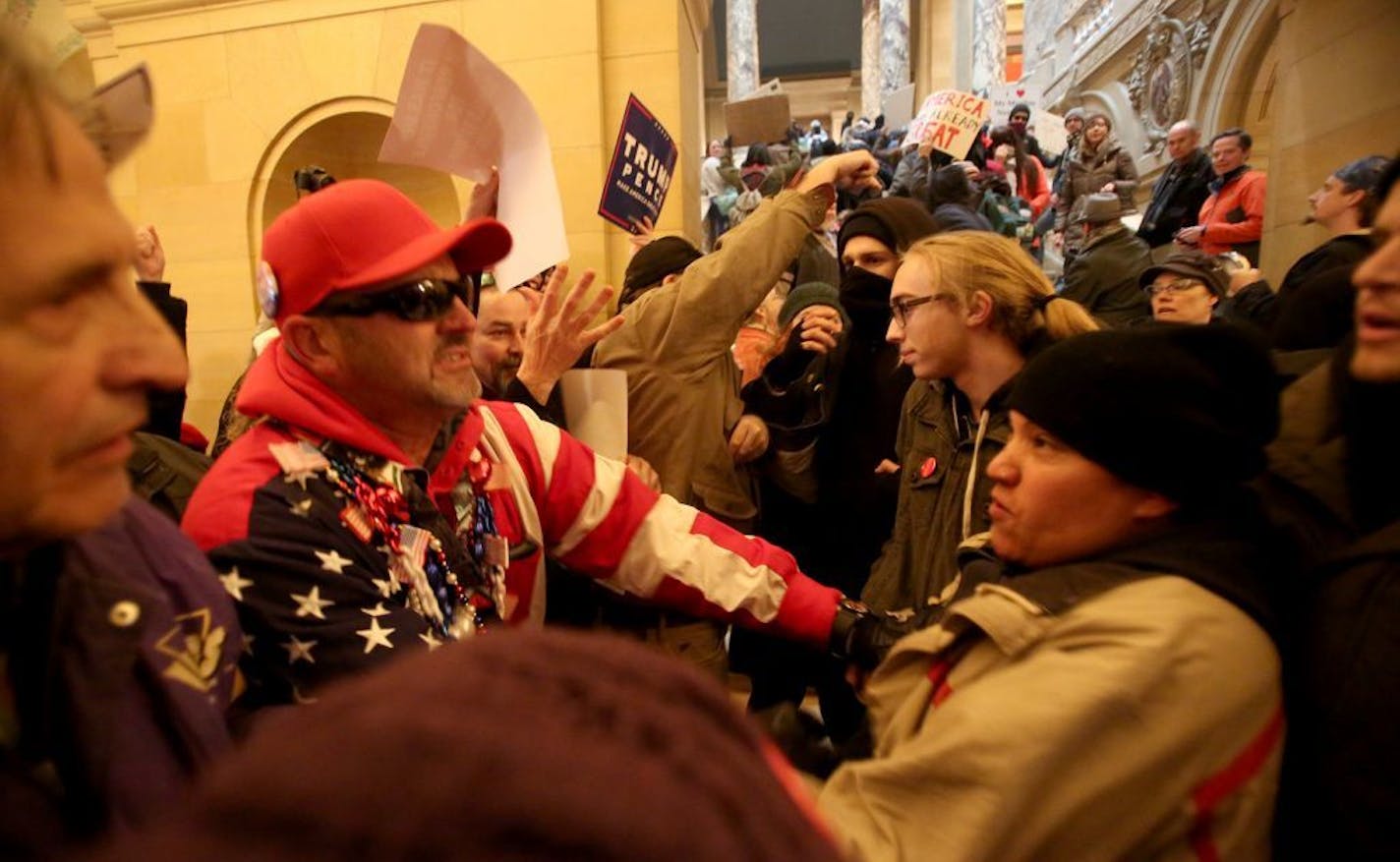 Supporters of President Donald Trump and anti-Trump protesters clashed in the hallway outside the rotunda at a national March4Trump Saturday, March 4, 2017, at the State Capitol in St. Paul, MN.