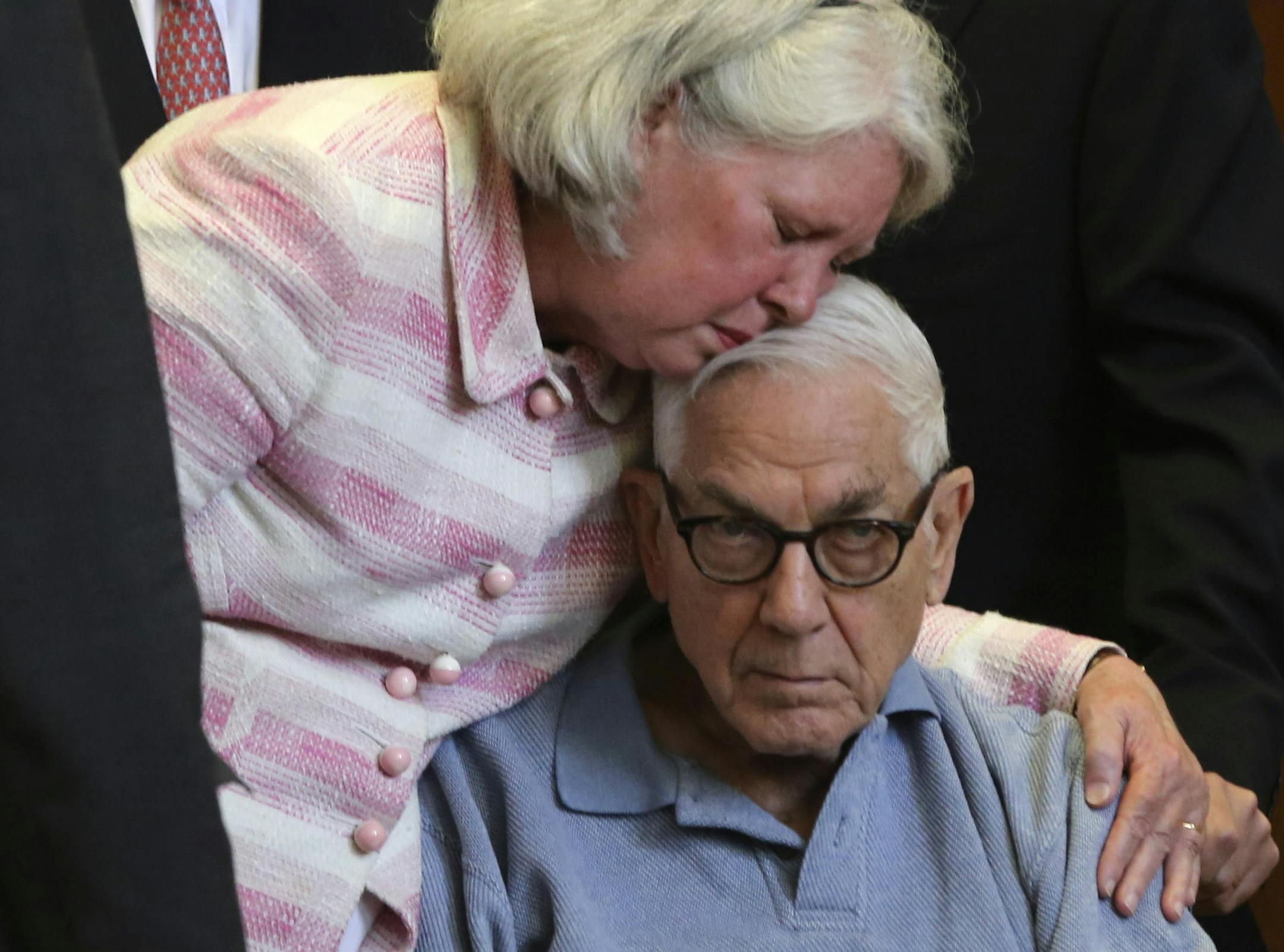 Anthony Marshall is kissed by his wife Charlene Marshall as he arrives at criminal court with his attorneys, Friday, June 21, 2013 in New York. The 89-year-old heir convicted of helping himself to his mother Brooke Astor's fortune surrendered Friday after years of fighting his conviction to begin his prison term. (AP Photo/Mary Altaffer)