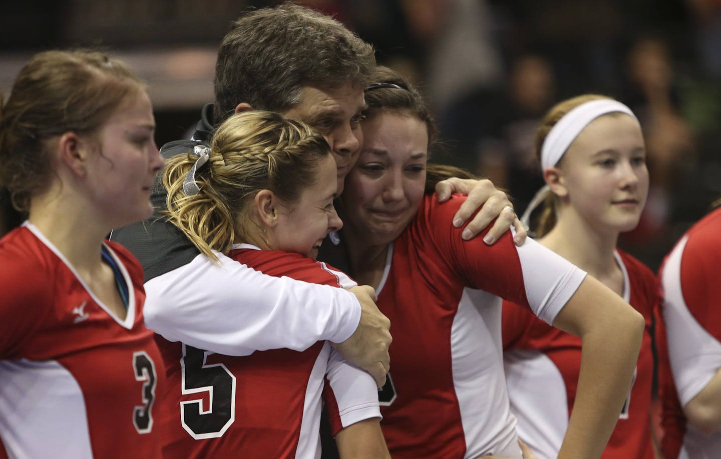 Franz Boelter hugged some of his players after Faribault Bethlehem Academy won the Class 1A volleyball title in 2012.