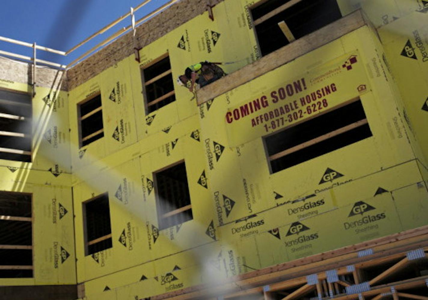 A worker constructions West Broadway Curve, an affordable housing project on West Broadway Avenue, this August.