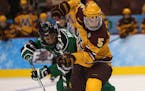 Gophers defenseman Mike Reilly, battling North Dakota's Mark MacMillan during Minnesota's 2014 Frozen Four victory, picked the Wild over other NHL tea
