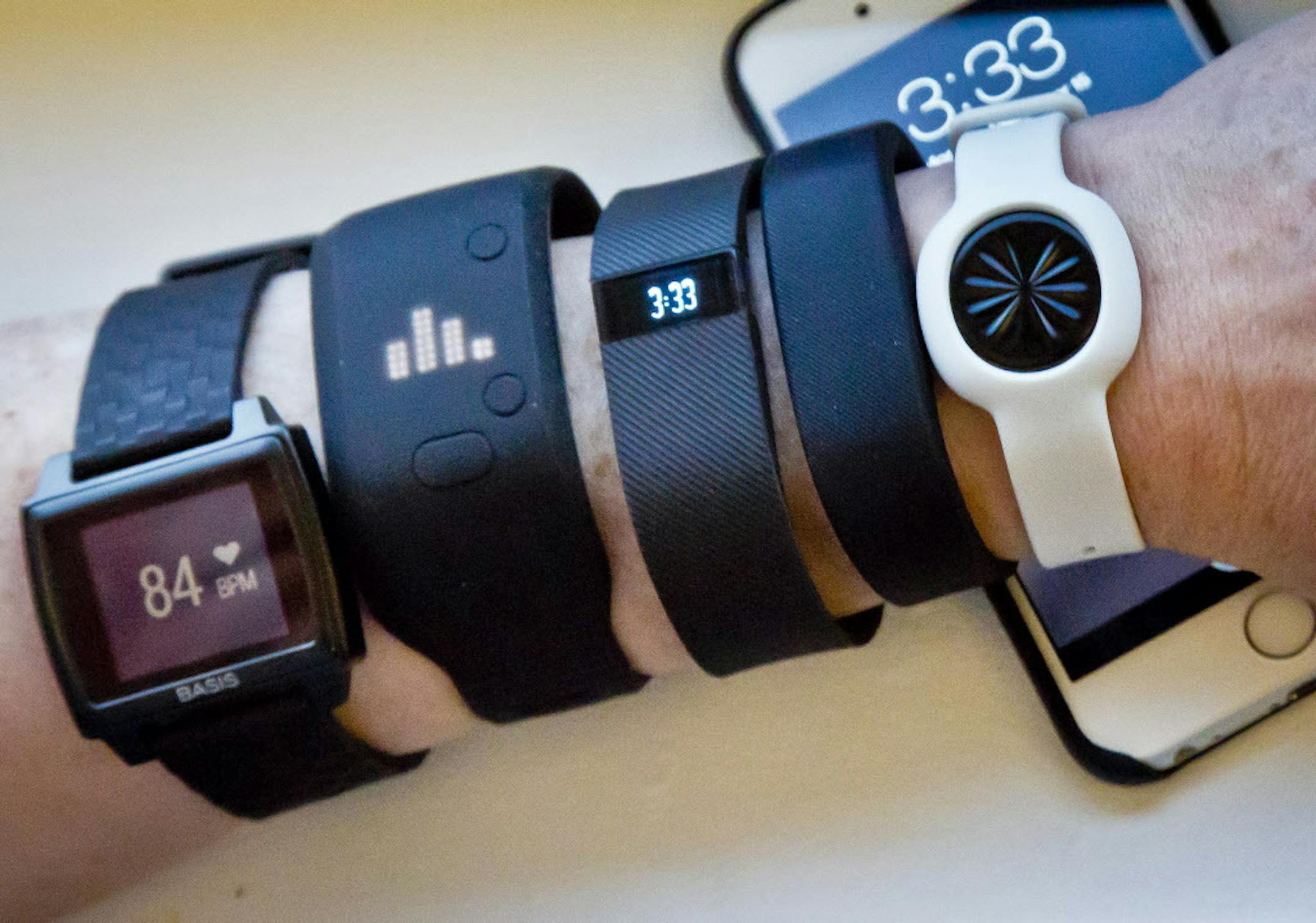 Ffitness trackers, from left, Basis Peak, Adidas Fit Smart, Fitbit Charge, Sony SmartBand, and Jawbone Move. (AP Photo/Bebeto Matthews, File) ORG XMIT: MIN2015062209331917