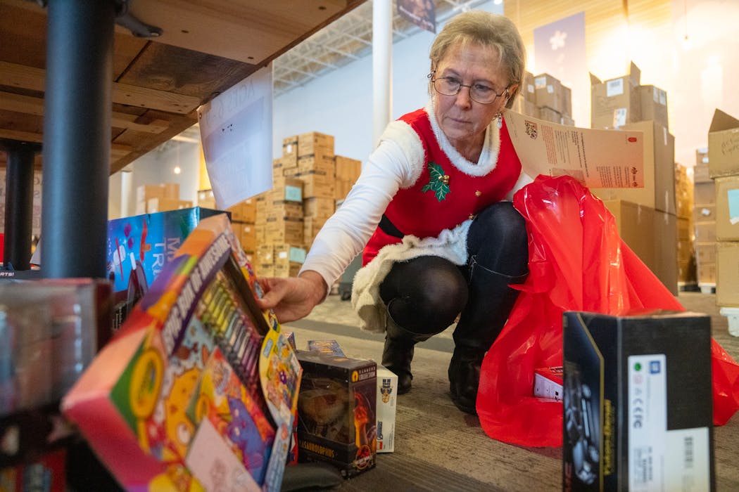 Cathy Clark and other volunteers picked out toys Wednesday during the first day of the Salvation Army Toy Shop, at Woodland Hills Church in St. Paul.