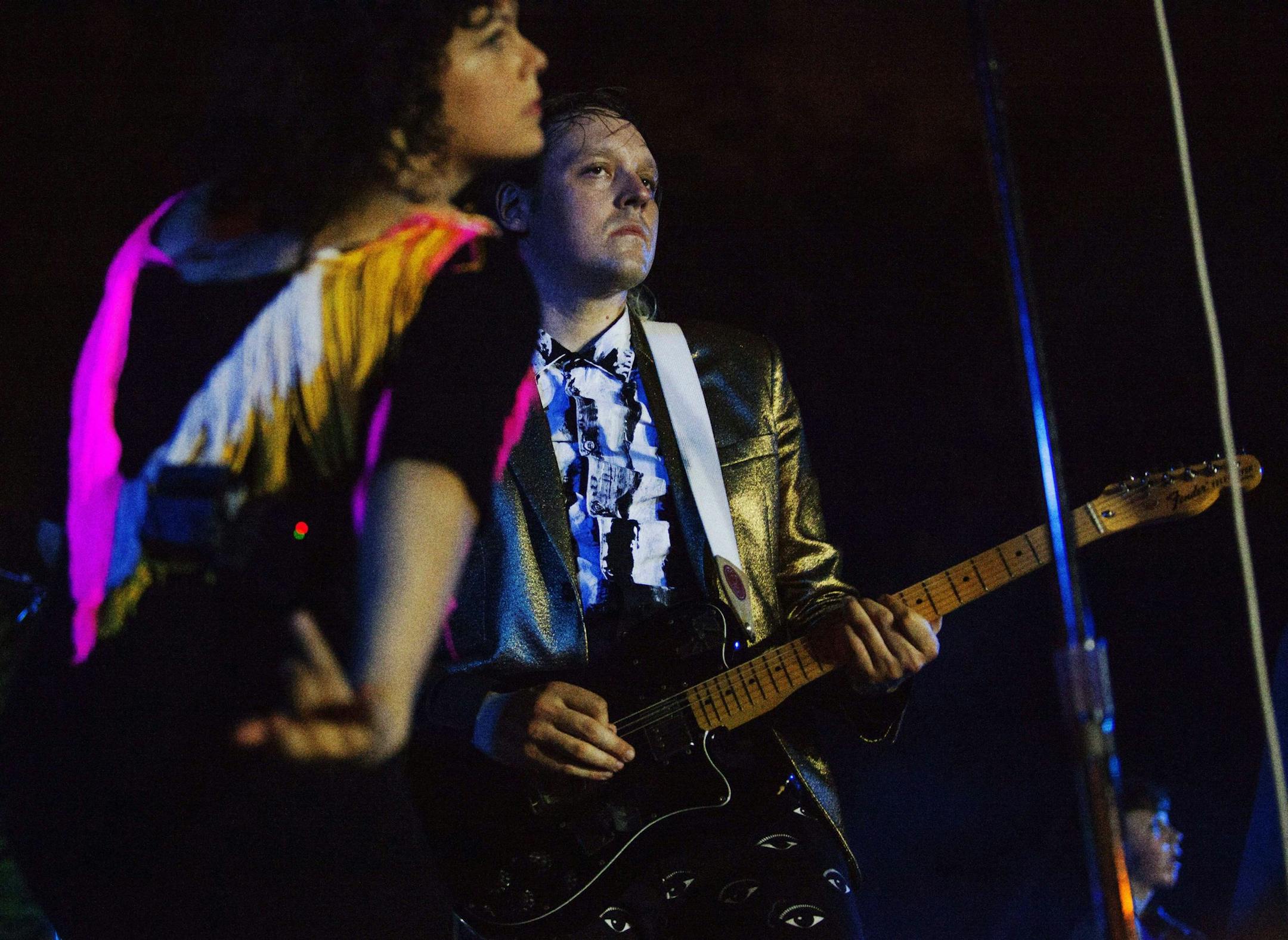 Win Butler, right, and his wife and bandmate Regine Chassagne, left, of Arcade Fire, perform Oct. 24, 2013 at the Little Haiti Cultural Center in Miami. Arcade Fire's new album "Reflektor" comes out next week. The Thursday night show at the Little Haiti Cultural Center was the second of two Miami performances this week that billed the band as "The Reflektors." Arcade Fire's new album "Reflektor" comes out next week. (AP Photo/Eric Kayne)