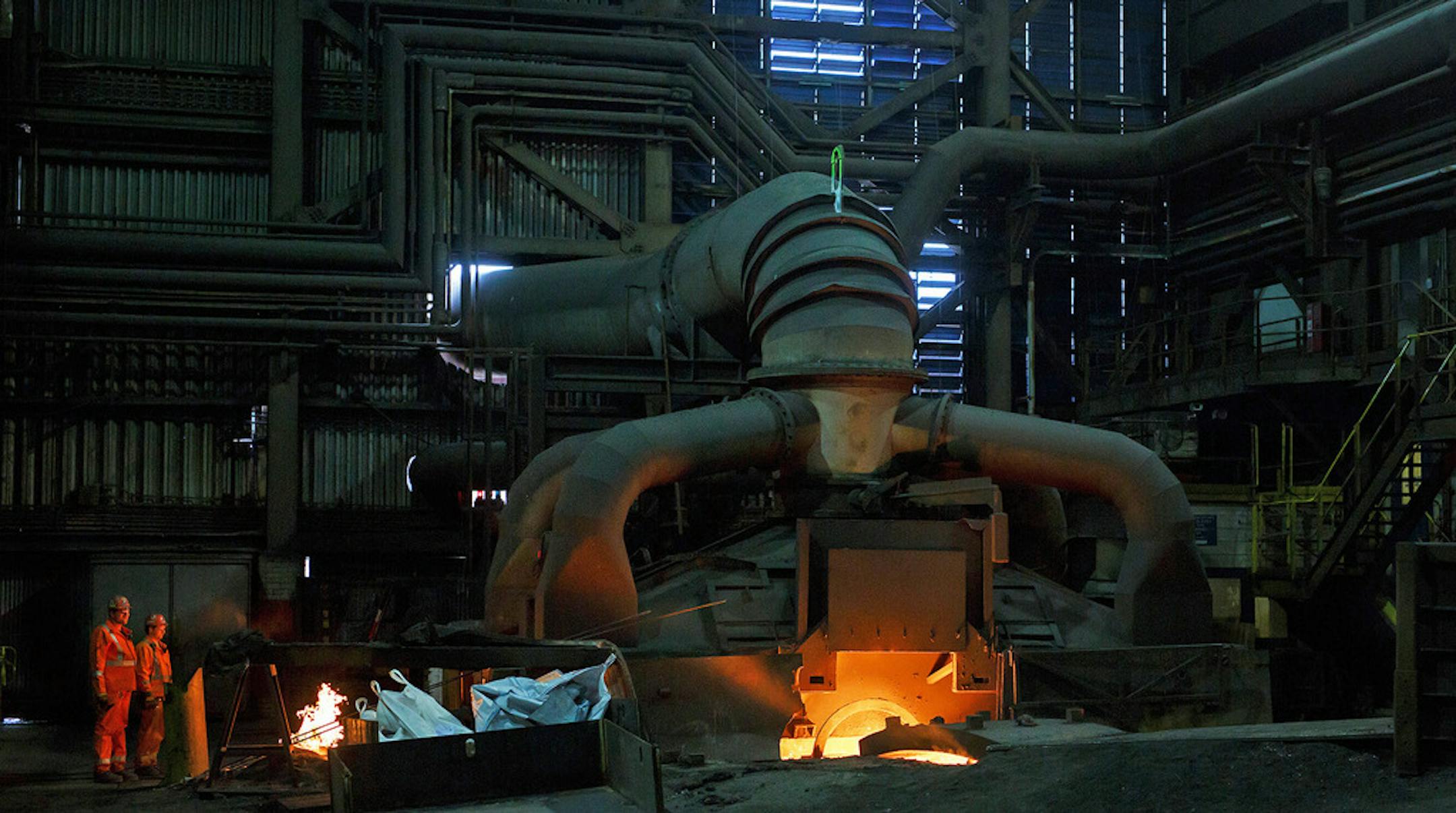 Employees are illuminated by the glow of molten steel at the Stelco Holdings plant in Nanticoke, Ontario, this month.