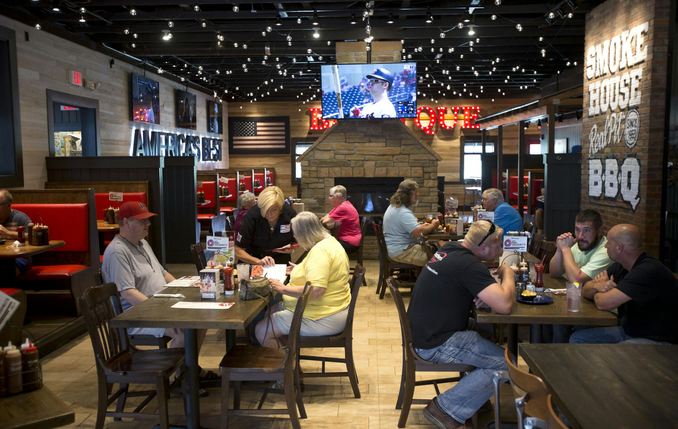 Lunch patrons sit in the main dining room at Famous Dave's in Coon Rapids to enjoy a meal off their new menu. ] ALEX KORMANN &#x2022; alex.kormann@startribune.com Famous Dave's Coon Rapids location recently did a twelve week menu overhaul where they introduced new dishes to only that location as an experiment of sorts. New items include chicken and waffles, jalape&#xf1;o and cheddar stuffed sausage, mini doughnuts and a sweet potato souffl&#xe9;. The new menu has pulled in more customers excited