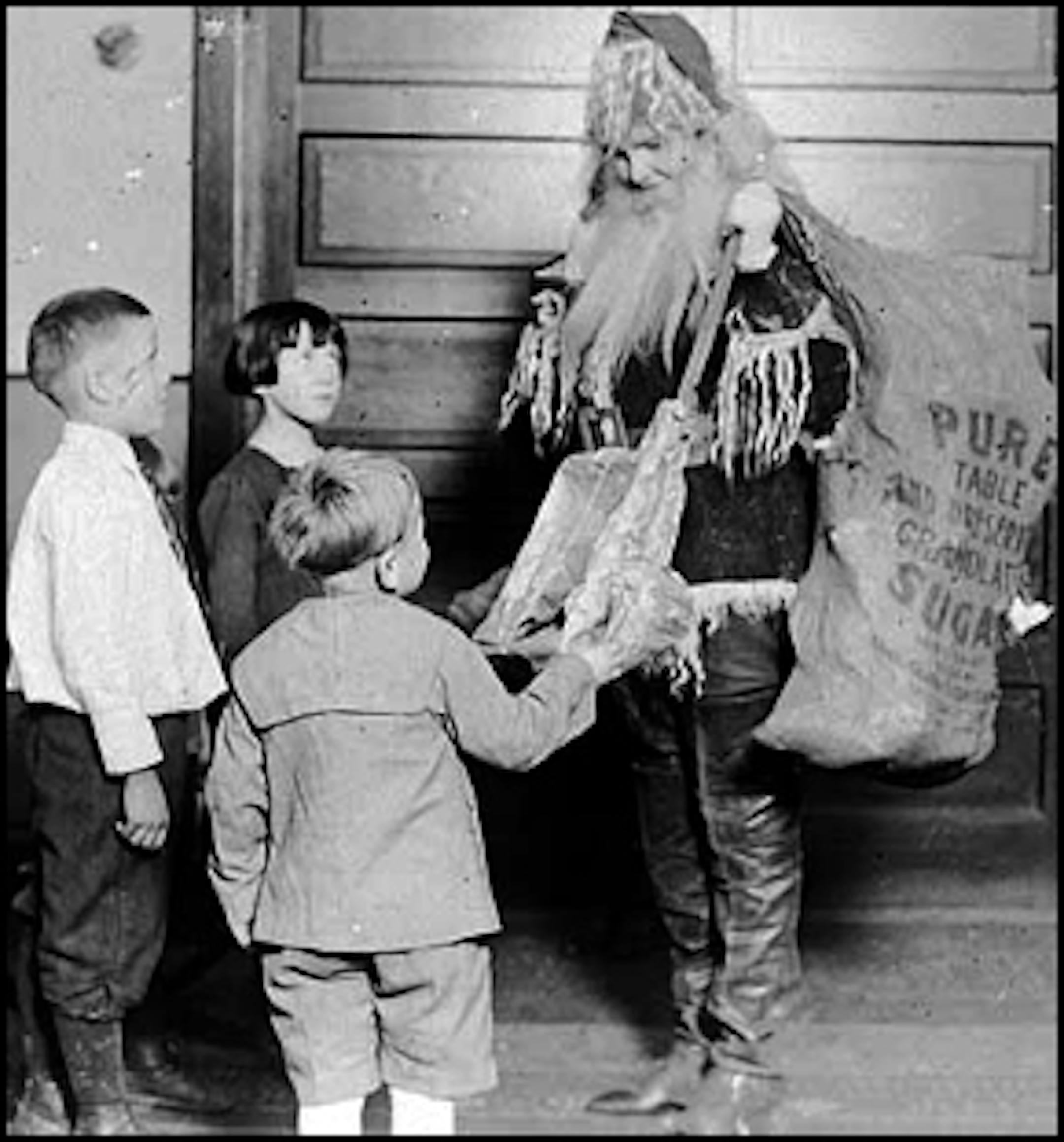 You're not fooling anyone: A decidedly feminine Santa Claus passed out gifts at Northeast Neighborhood House, Minneapolis, in about 1925.