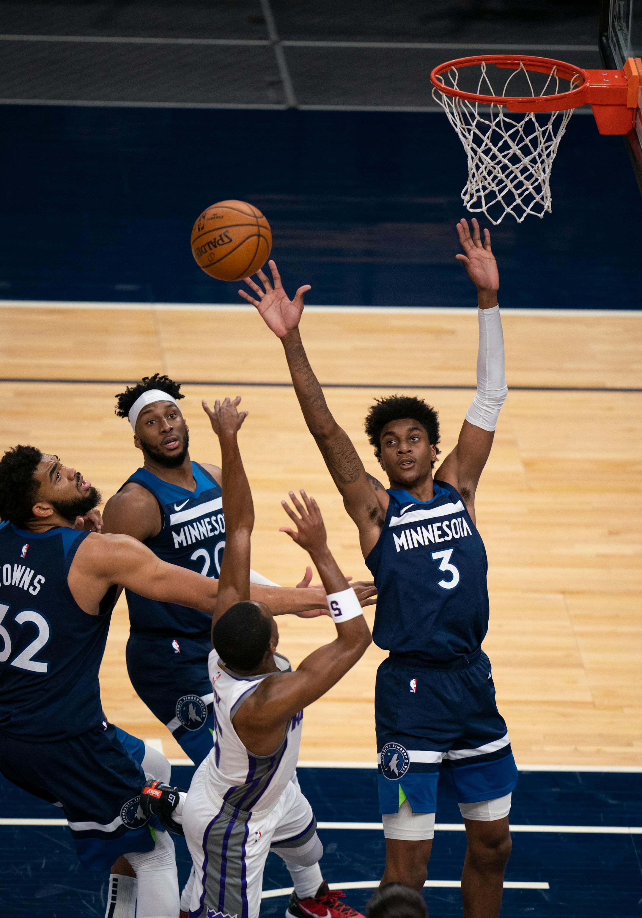 Sacramento Kings guard De'Aaron Fox (5) was fouled by Minnesota Timberwolves forward Jaden McDaniels (3) in the second quarter.