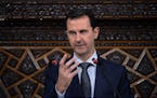 In this photo released by the Syrian official news agency SANA, Syrian President Bashar Assad, addresses a speech to the newly-elected parliament at t