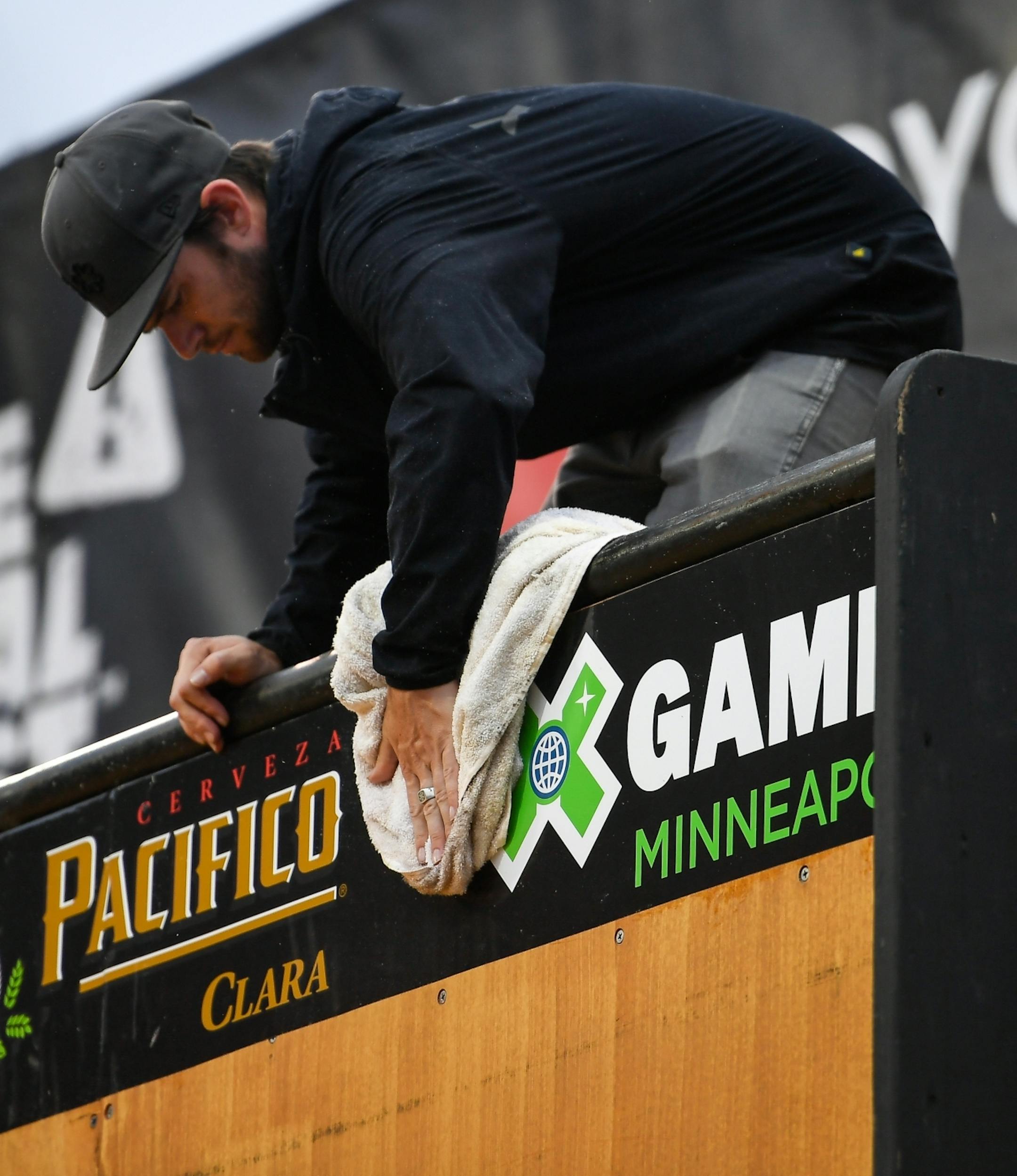 Workers attempted to clear water from the vert ramp Thursday after a short rain fall.