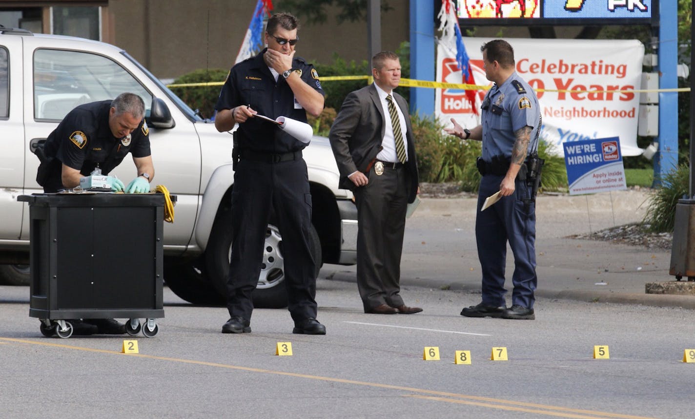 St. Paul police investigators analyze the scene at wabasha and Plato where a suspect involved in vandalism was shot and killed by police. ] Brian Peterson/Star Tribune