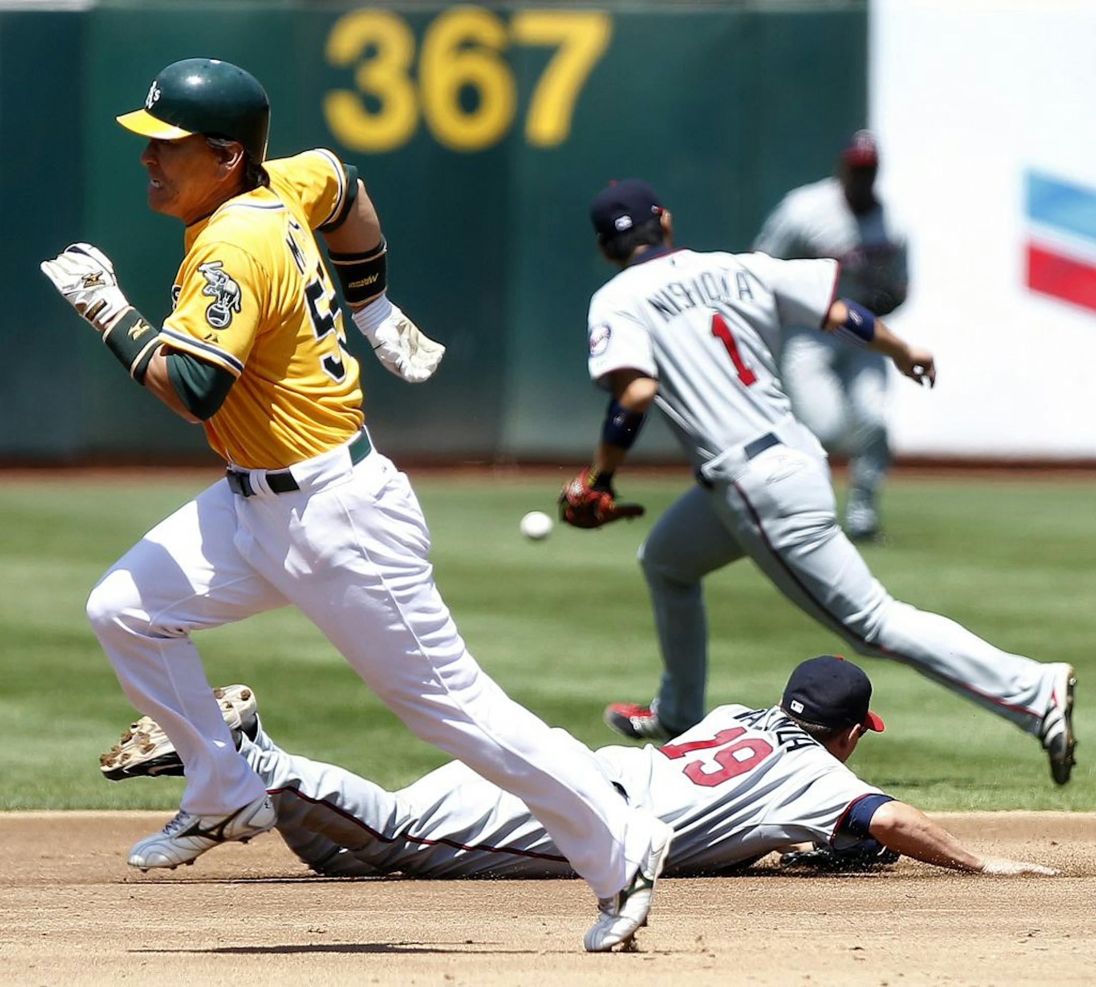 Oakland Athletics base runner Hideki Matsui rounds second on his way to home plate after A's batter Conor Jackson singled in the third inning against the Minnesota Twins on Sunday, July 31, 2011 at O.co Coliseum in Oakland, California. The A's beat the Twins by a score of 7-3.