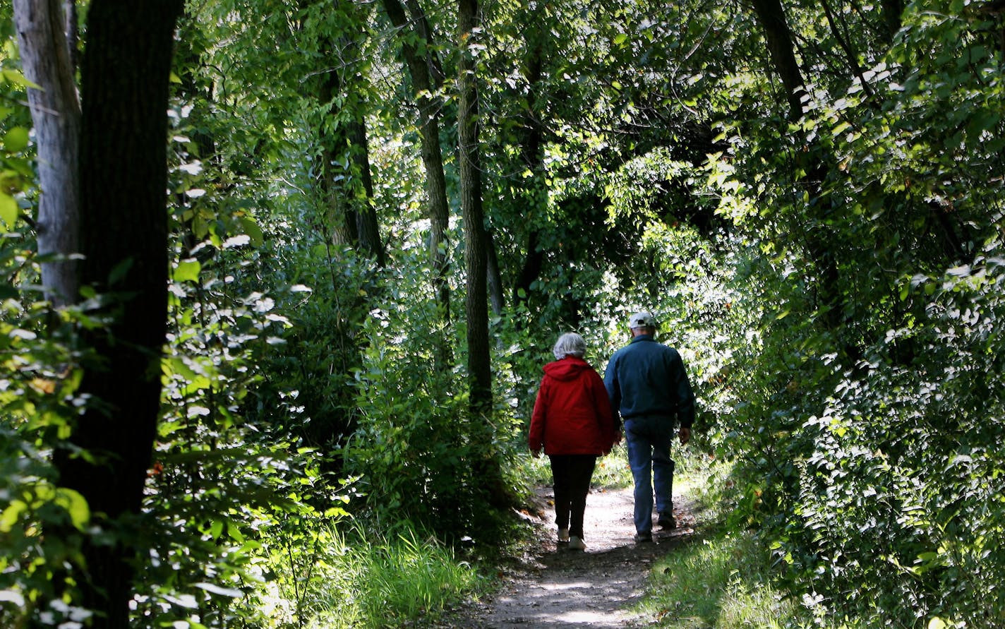 FILE -- A couple head down a trail along Jensen Lake in Lebanon Hills Regional Park.