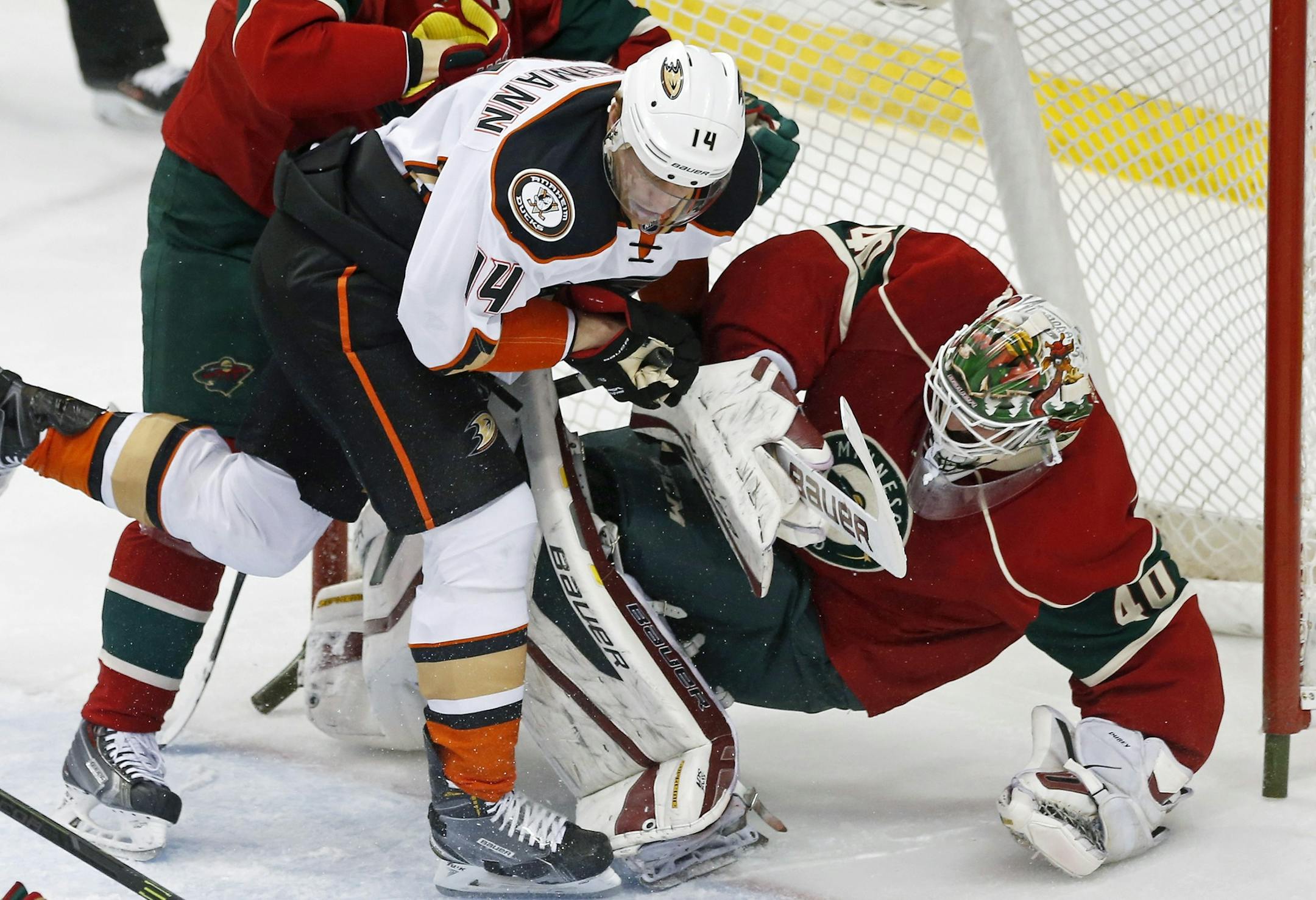 Minnesota Wild goalie Devan Dubnyk, right, is upended by Anaheim Ducks’ Tomas Fleischmann, of the Czech Republic, in the first period of an NHL hockey game, Friday, March 13, 2015, in St. Paul, Minn. Fleischmann received a two-minute penalty for goaltender interference. (AP Photo/Jim Mone)