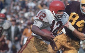 O.J. Simpson ran past the Gophers' Bob Stein on his way to 236 rushing yards and four TDs in USC's 29-20 victory in the 1968 opener.