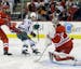 Carolina Hurricanes' Jay Harrison (44) defends as Minnesota Wild's Jason Pominville (29) scores on Hurricanes goalie Justin Peters (35) during the fir