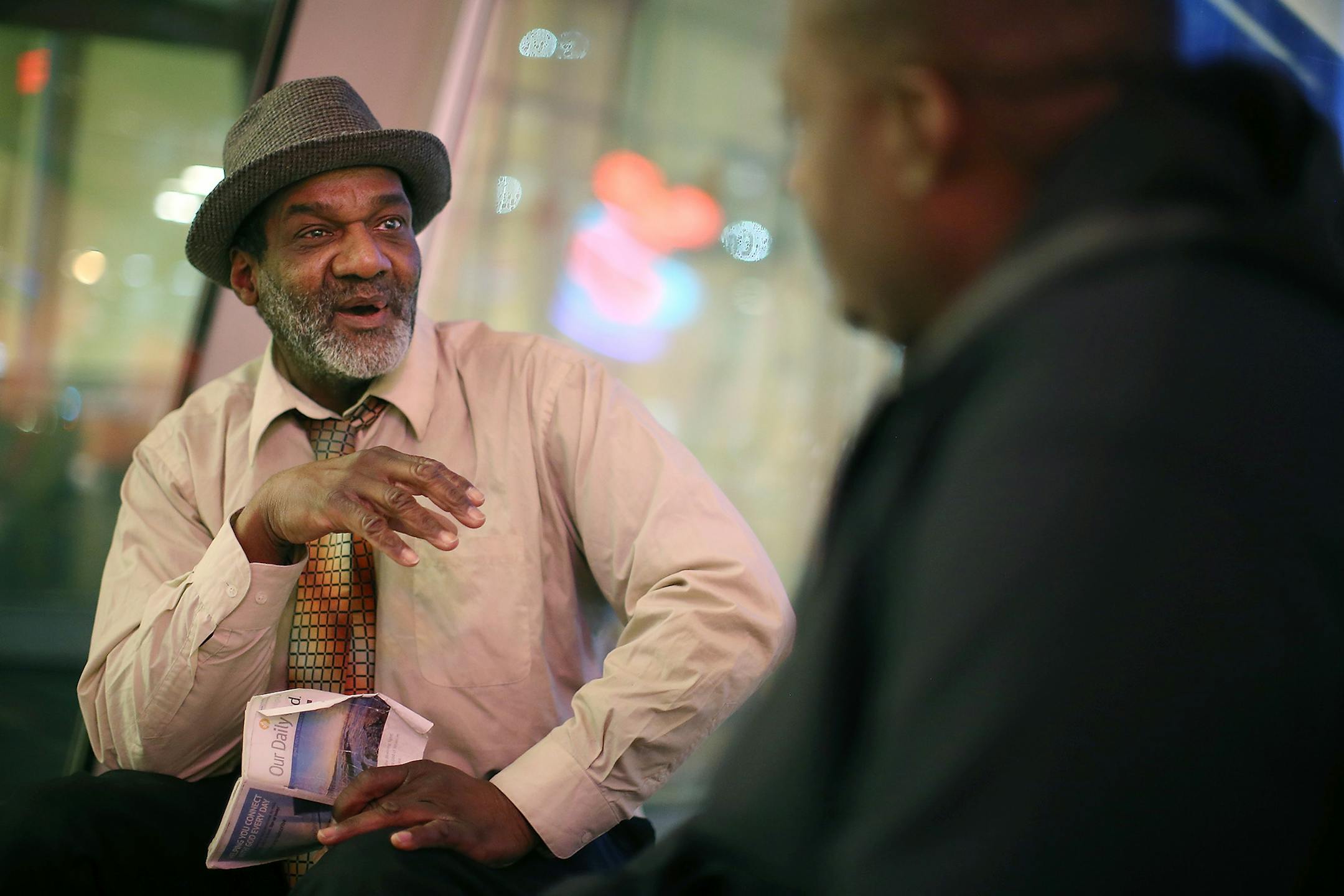 David Jeffries, the Director of Single Adult Programs for St. Stephen's Human Services, right, listened to Roland Arnold as he spent the morning reading his devotional book at the Hennepin County Library, Thursday, January 28, 2015 in Minneapolis, MN. Many of the homeless sit in the library for the day. The St. Stephen Outreach program participated in an annual count as they scoured the city to count unsheltered homeless people.