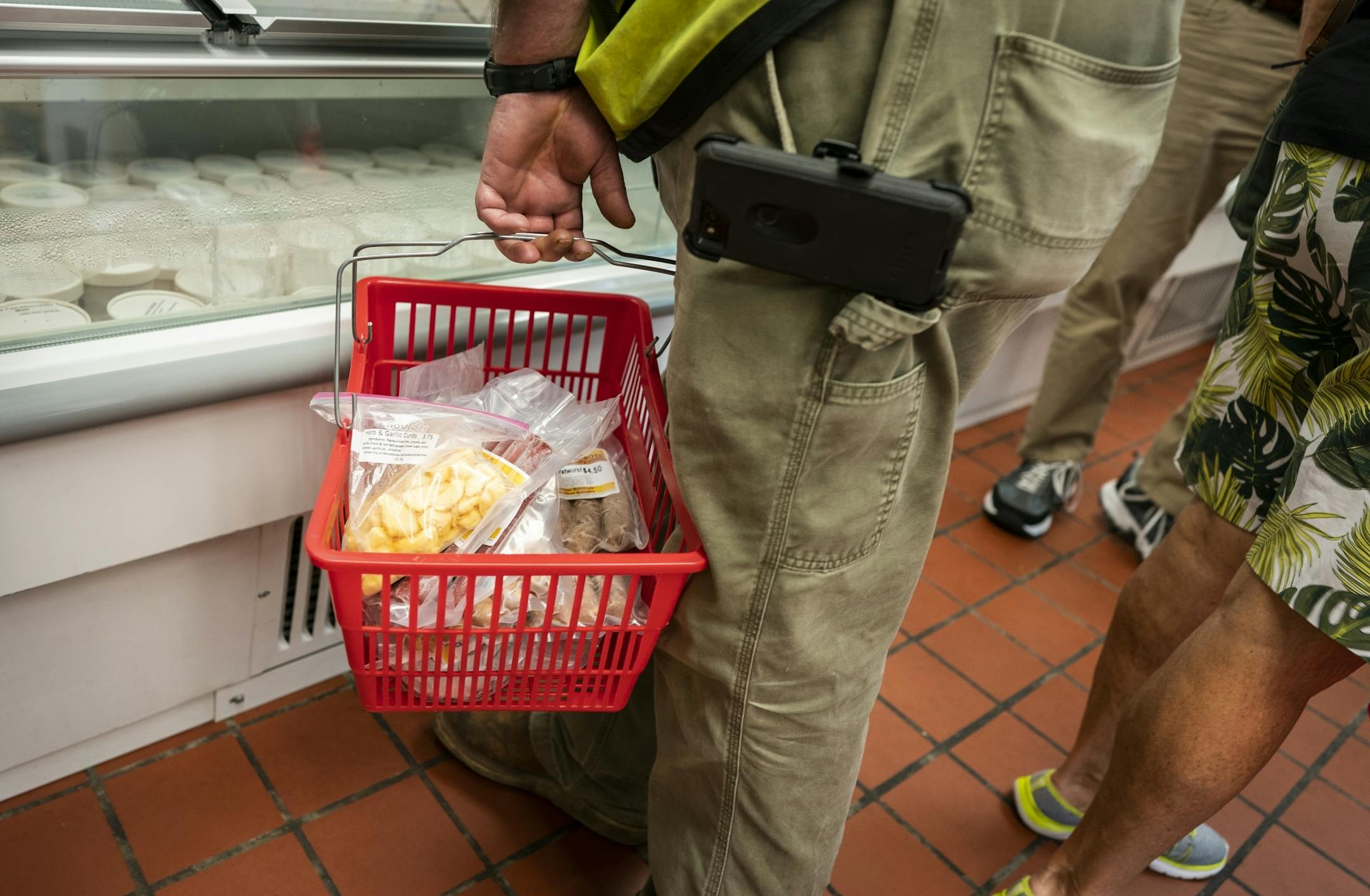A customer loads up on meat and cheese at the Meat and Dairy salesroom.