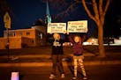 Friends Olivia Bremer, left, and Skylar Bouman, both 9, of Waconia, waved signs in support of the more than 140 veterans who took part in a whirlwind 