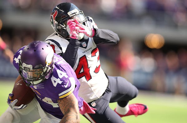 Vikings running back Matt Asiata was tackled by Texans defensive back Corey Moore just short of the end zone during the third quarter.