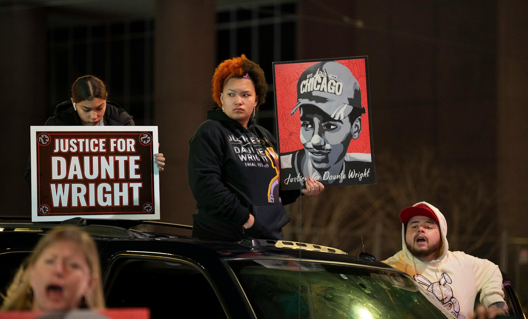 After a rally outside the Hennepin County Government Center, Daunte Wright's siblings, Diamond, center, and Damik, right, accompanied demonstrators on a short march through downtown Tuesday evening, Nov. 30, 2021 in Minneapolis. A demonstration of support for the family of Daunte Wright by 75 or so people took place Tuesday, Nov. 30, 2021 outside the Hennepin County Government Center followed by a short march in Minneapolis. ] JEFF WHEELER • Jeff.Wheeler@startribune.com