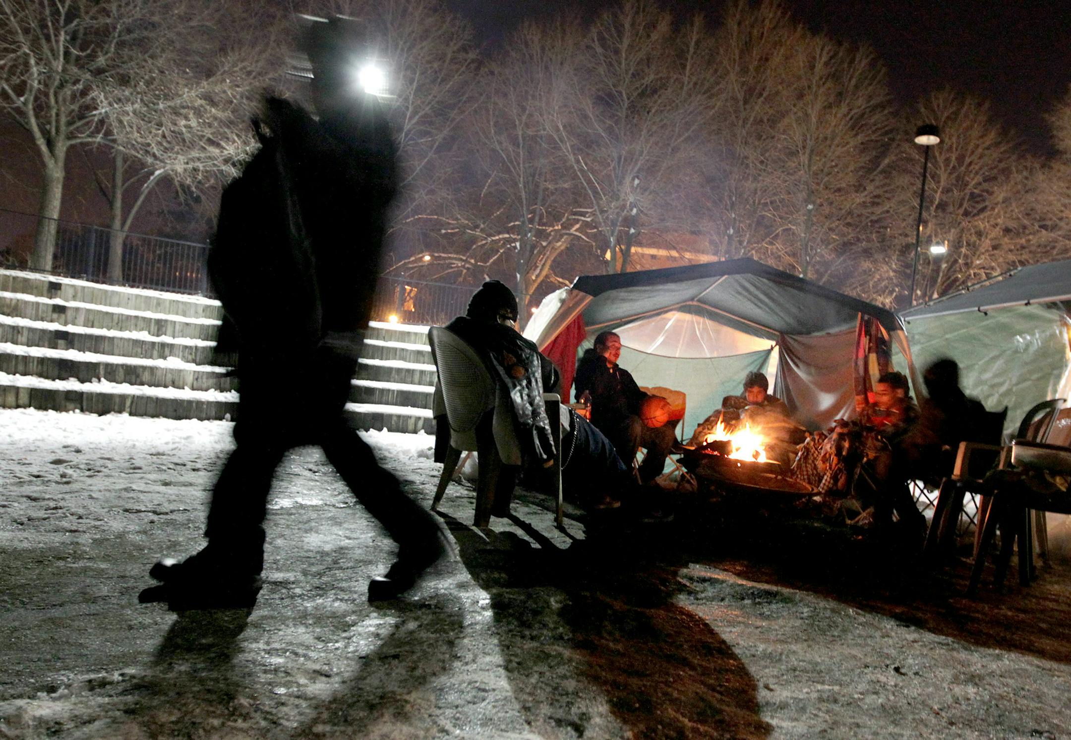 Friends keep a ceremonial fire burning for Trinidad Flores, 16, who died after a heart transplant, at his wake at the Minneapolis American Indian Center April 19, 2013. The fire burns for 4 days to light the way for his spirit.