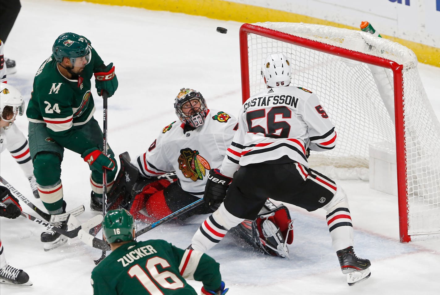 The Wild's Matt Dumba, left, watches the puck along with Blackhawks' goalie Corey Crawford a moment before Dumba scored the winning goal