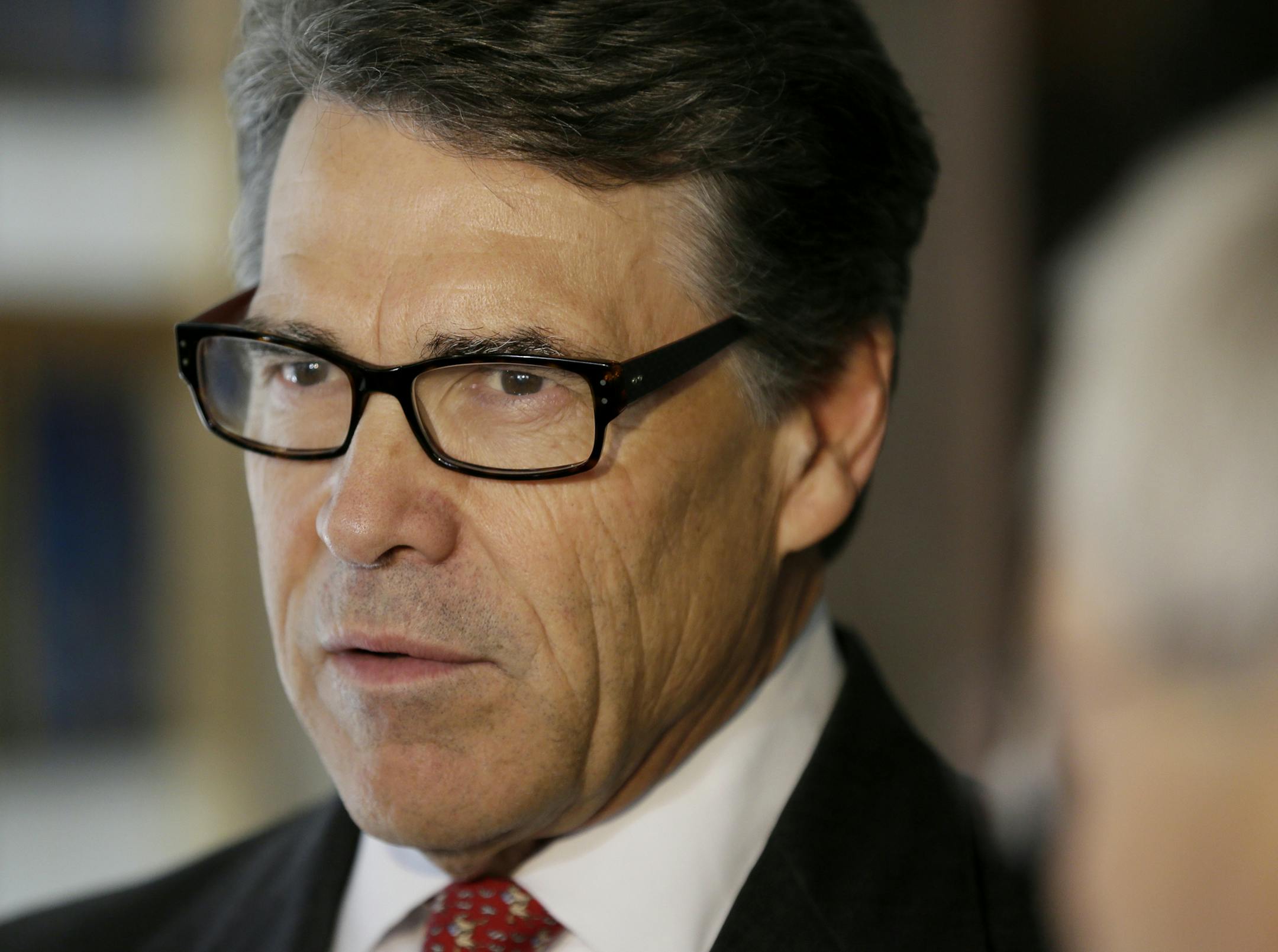This photo taken May 29, 2014 shows Texas Gov. Rick Perry speaking in Ames, Iowa. Two leading Republicans have begun an unusually personal a war of words over foreign policy. The dispute between Kentucky Sen. Rand Paul and Texas Gov. Rick Perry highlights a broader divide within the GOP over international affairs in one of the first public clashes of the Republican Partyís looming presidential primary. (AP Photo/Charlie Neibergall)
