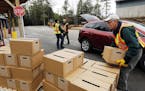 FILE - In this Monday, April 11, 2016 file photo, New Hampshire state and local officials load boxes of free bottled water in in Litchfield, N.H. New 