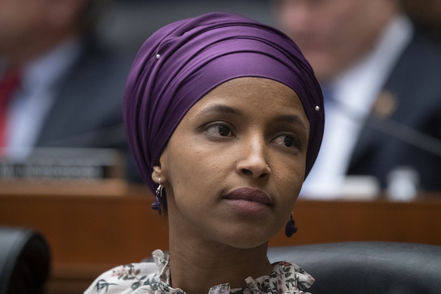 FILE - In this March 6, 2019, file photo, Rep. Ilhan Omar, D-Minn., sits with fellow Democrats on the House Education and Labor Committee during a bill markup, on Capitol Hill in Washington. President Donald Trump is weighing in on the most recent controversy involving Omar, retweeting video edited to suggest that the Minnesota congresswoman was dismissive of the significance of the Sept. 11 attacks. (AP Photo/J. Scott Applewhite, File) ORG XMIT: MER5270c0a69499dbff6b4dd2dd2e370