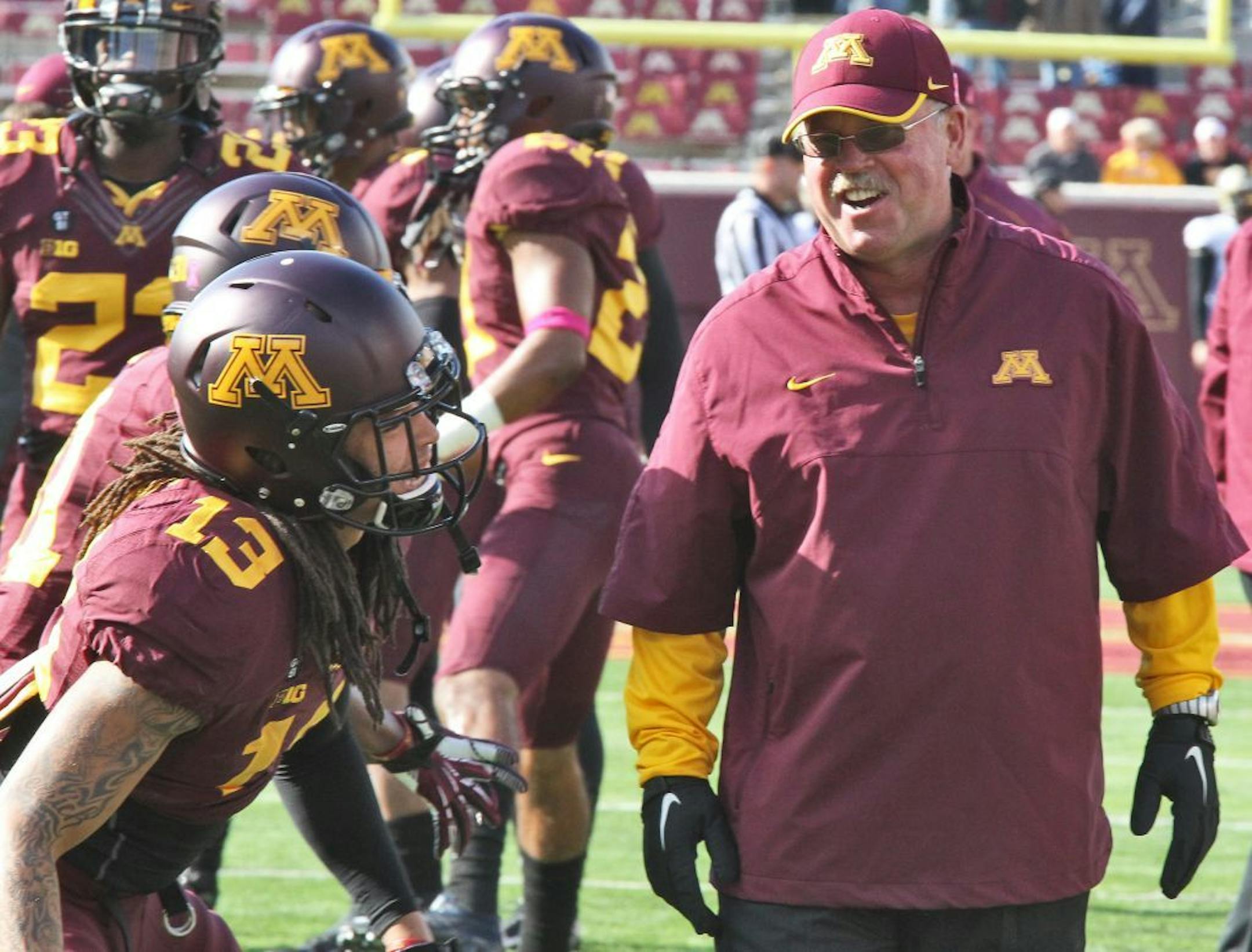 Minnesota head coach Jerry Kill shared a light moment with Derrick Wells