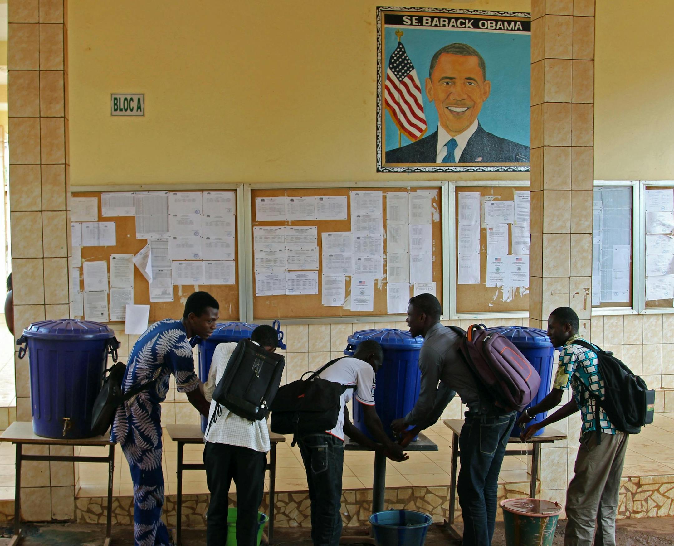 In this photo taken on Saturday, June 13, 2015, students at the Obama University wash their hands in Conakry, Guinea. Barack Obama, the United States’ first African-American president, has captured the imagination of people across the continent where his face shows up on billboards, backpacks, T-shirts and restaurants. On Friday, July 24, 2015 Obama will be visiting Kenya, where his father was born, for a summit on entrepreneurship before heading to Ethiopia to address leaders at the Afri